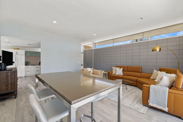 a living room with furniture and kitchen view