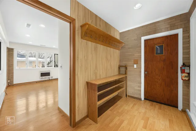a view of a bedroom with wooden floor and windows