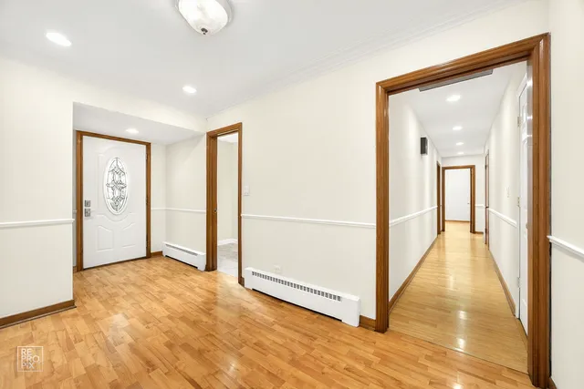 a view of a hallway with wooden floor