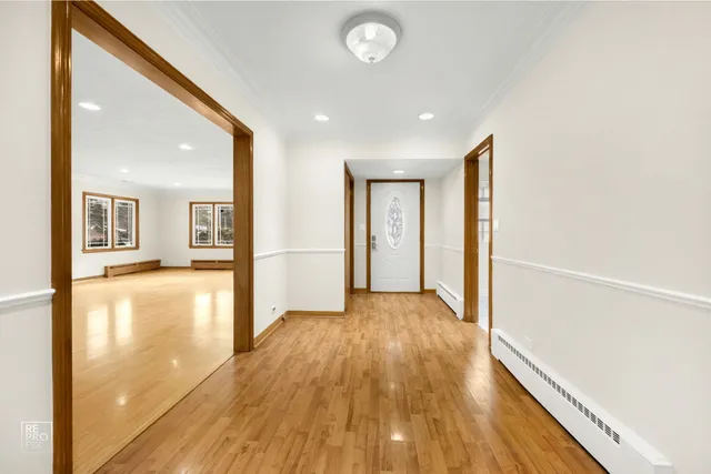 a view of a big room with wooden floor and a kitchen