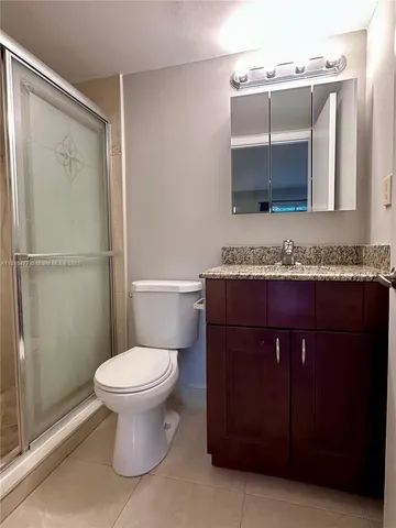 a bathroom with a sink toilet and mirror