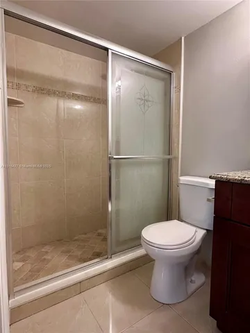 a bathroom with a shower and a toilet