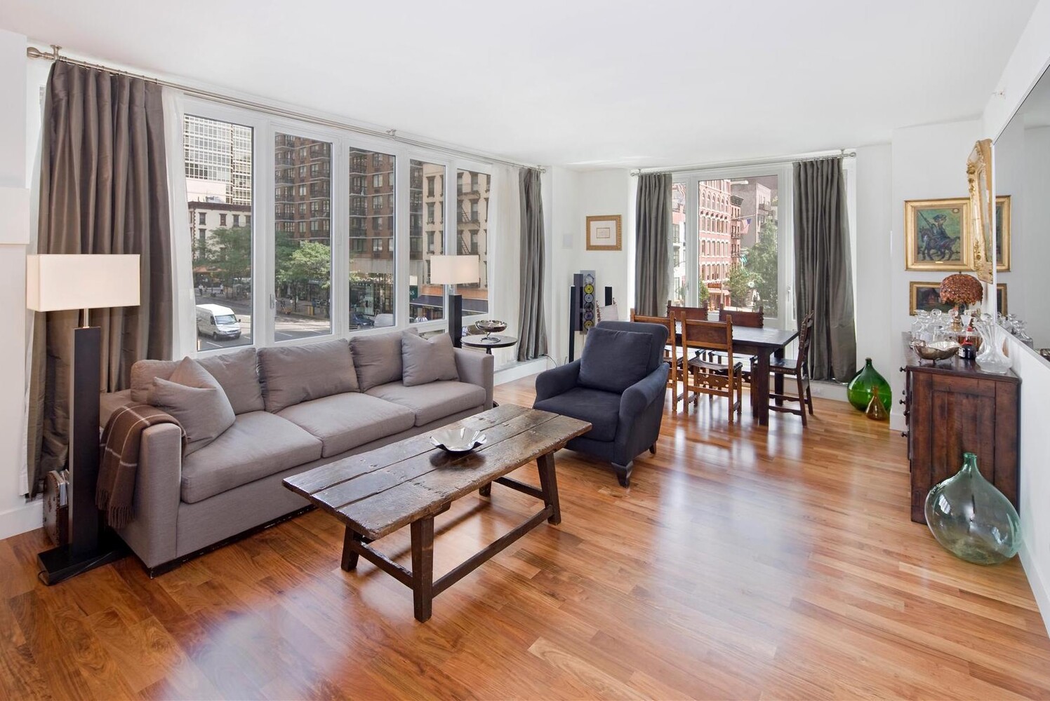 250 East 53rd Street, Unit 404 Manhattan, NY 10022 - Photo 1 of 12 a living room with furniture and a large window