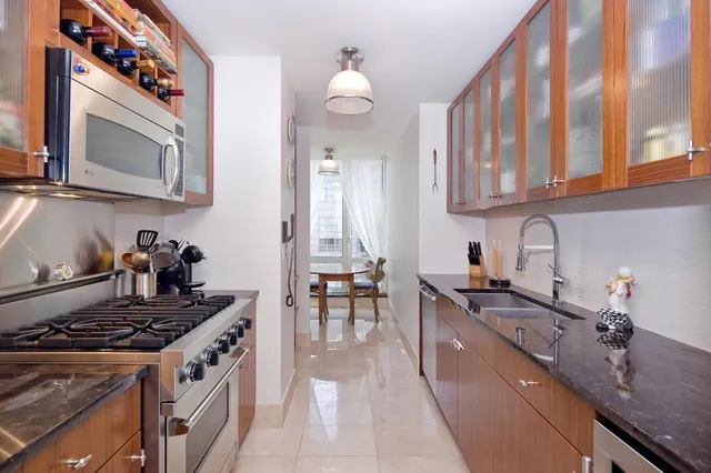 a kitchen with a stove a sink and a microwave