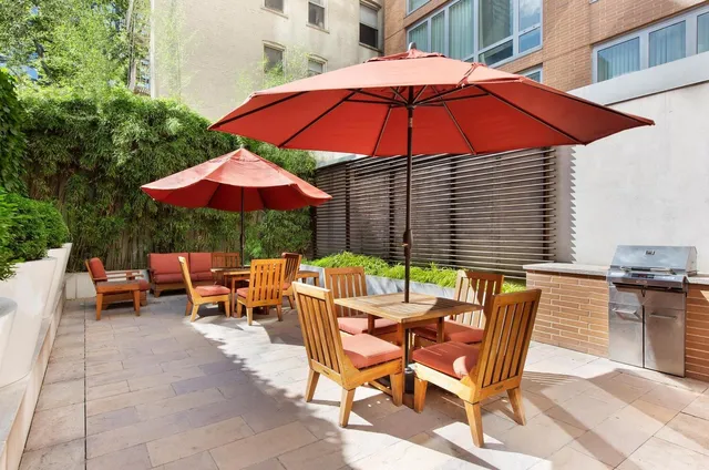 a view of backyard with outdoor seating and trees