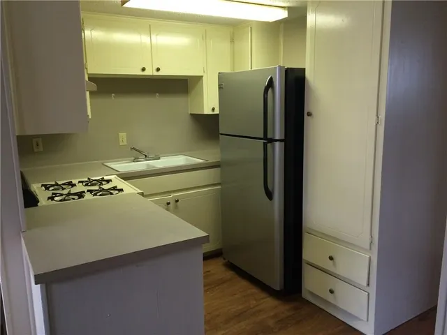 a kitchen with a refrigerator and a stove
