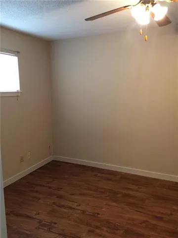 a view of a small space with wooden floor and a window