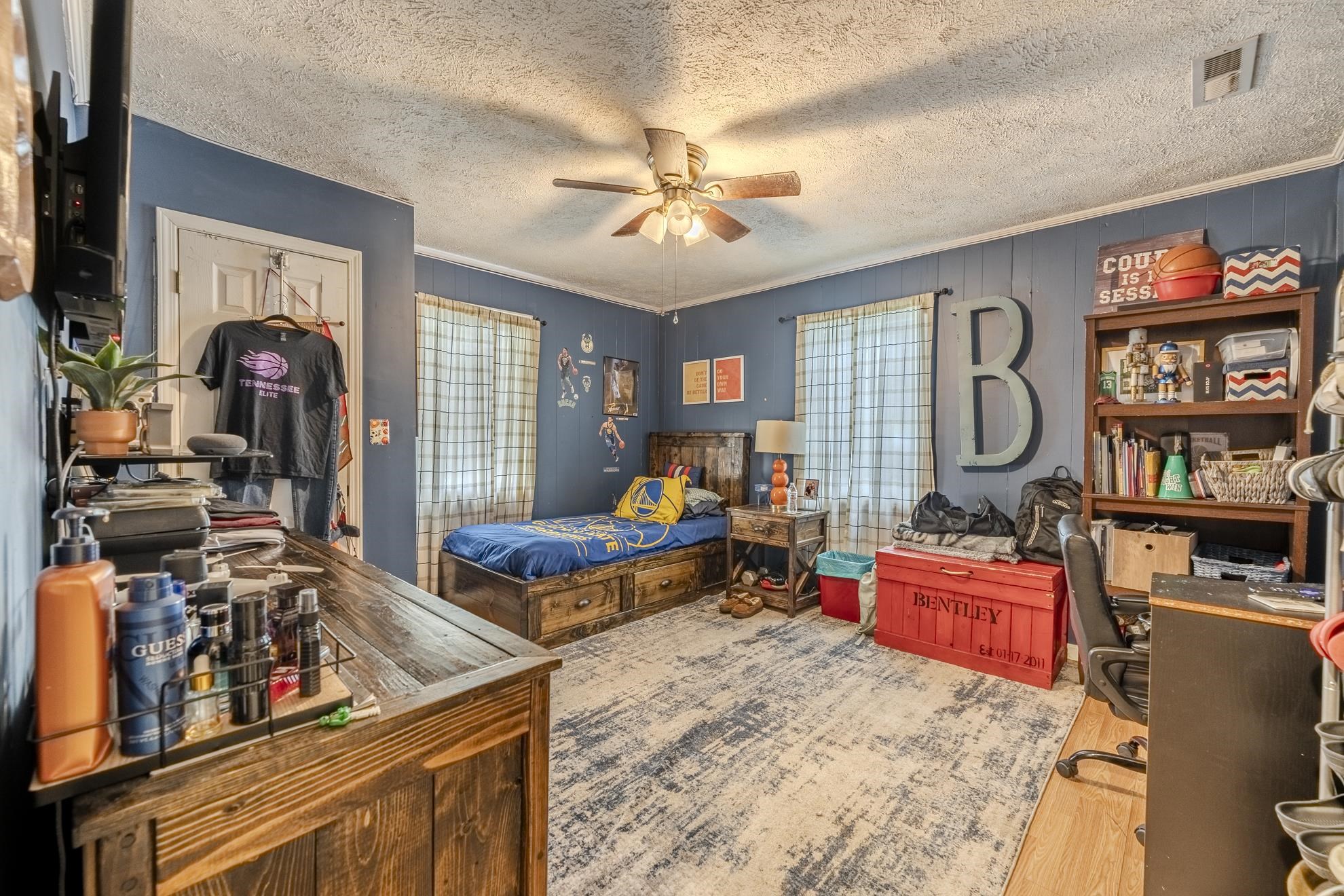 369 Bethel-Purdy Road Bethel Springs, TN 38315 - Photo 16 of 19 Room featuring wood-finish flooring, a ceiling fan, and painted paneling