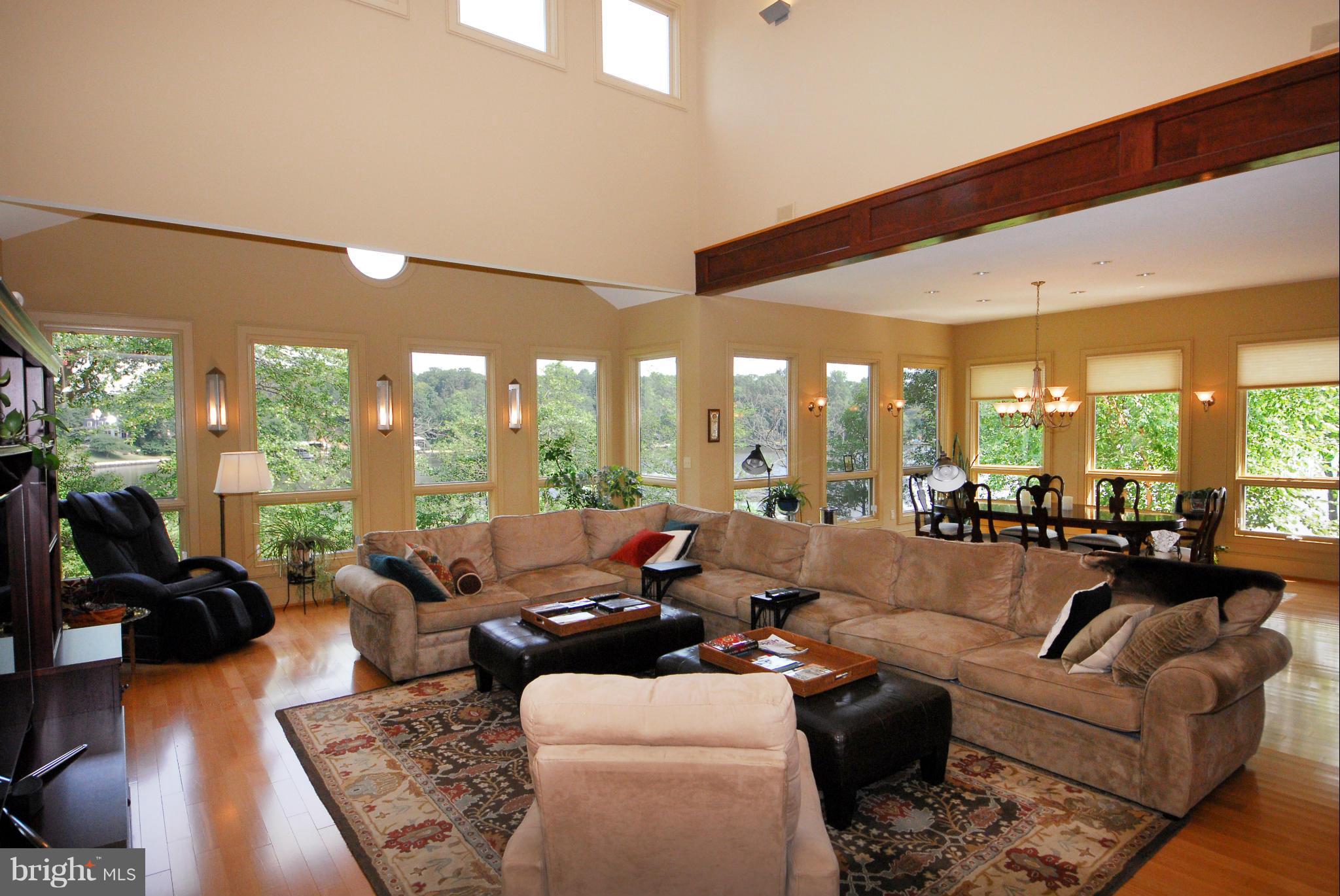 Great room has 30 ft ceilings & walls of windows