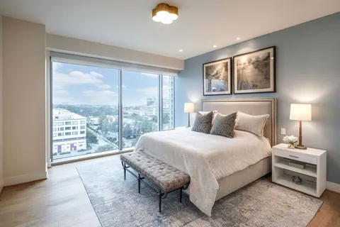 a bedroom with a large bed and a large window