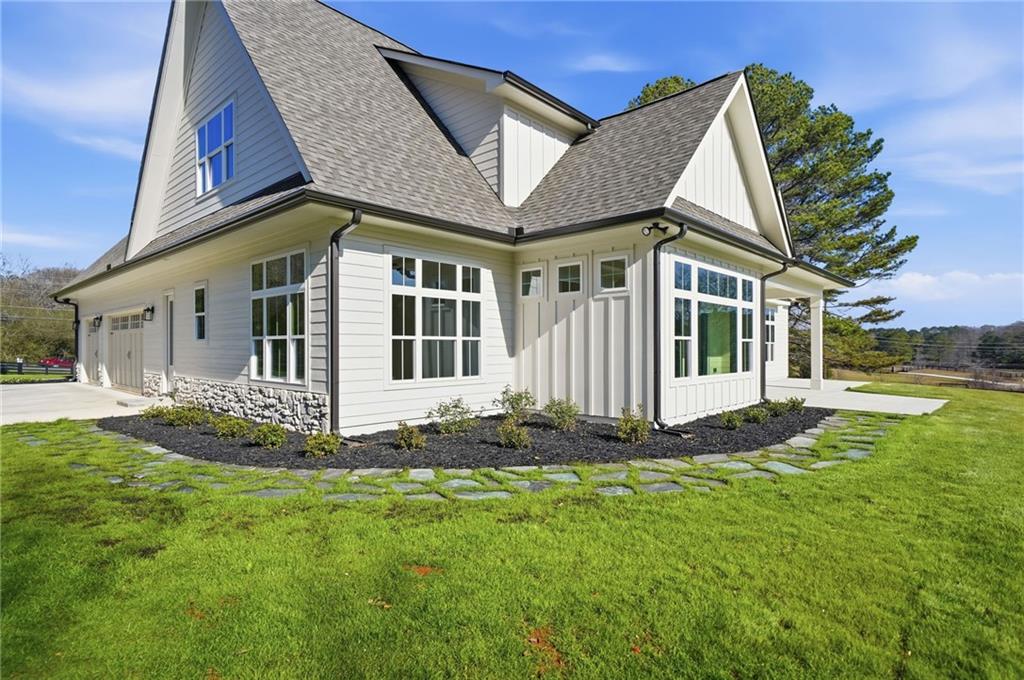 1248 Avery Road Canton, GA 30115 - Photo 15 of 64 a front view of a house with a garden
