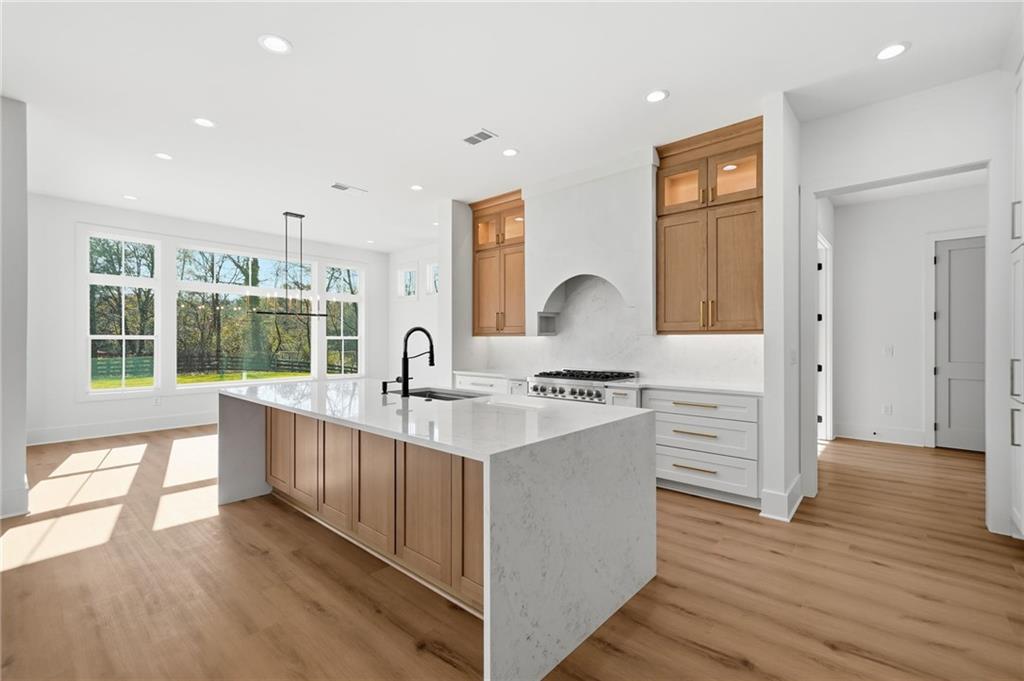1248 Avery Road Canton, GA 30115 - Photo 21 of 64 a kitchen with granite countertop a sink and a stove top oven