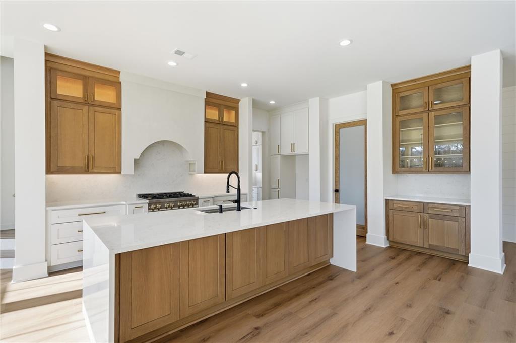 1248 Avery Road Canton, GA 30115 - Photo 23 of 64 a living room with stainless steel appliances granite countertop a sink dishwasher stove and wooden floor