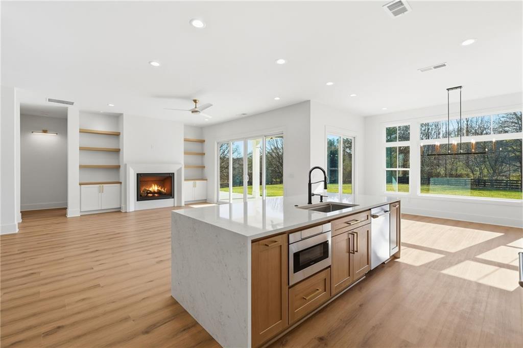 1248 Avery Road Canton, GA 30115 - Photo 24 of 64 a kitchen with stainless steel appliances granite countertop a stove and a sink