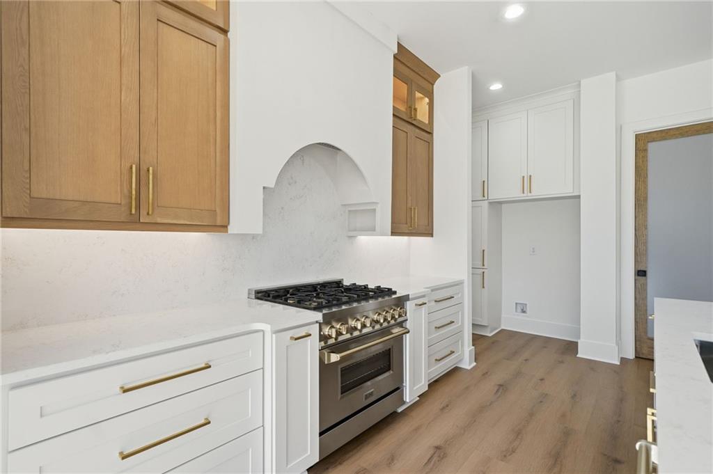 1248 Avery Road Canton, GA 30115 - Photo 26 of 64 a kitchen with stainless steel appliances granite countertop a stove and a refrigerator