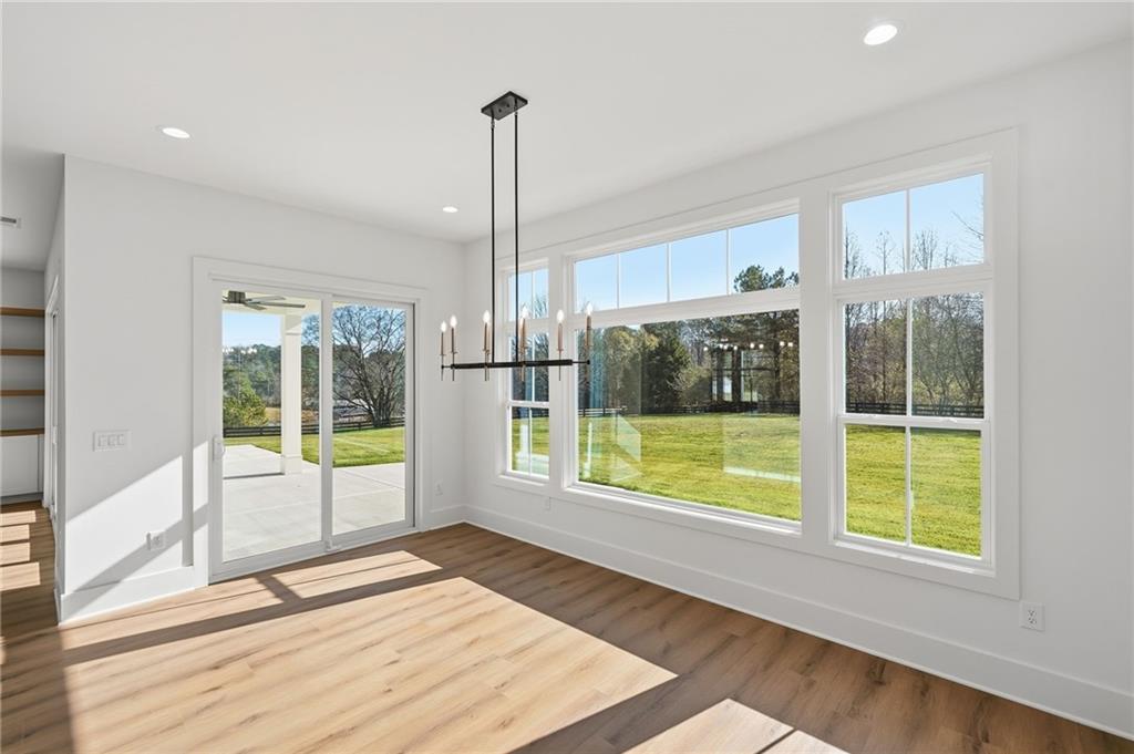 1248 Avery Road Canton, GA 30115 - Photo 30 of 64 a view of an empty room with wooden floor and a window