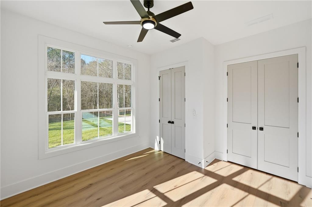 1248 Avery Road Canton, GA 30115 - Photo 34 of 64 a view of an empty room with a window and wooden floor