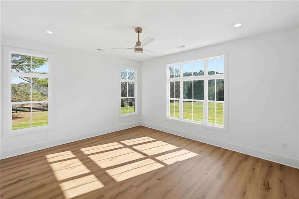 1248 Avery Road Canton, GA 30115 - Photo 36 of 64 a view of an empty room with wooden floor and a window