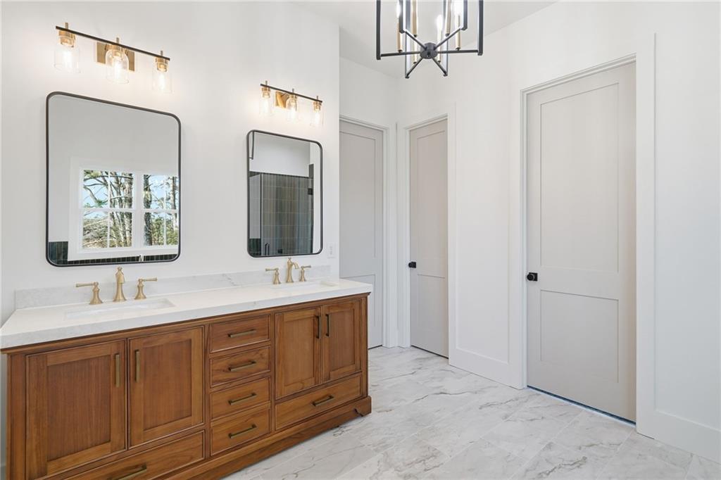 1248 Avery Road Canton, GA 30115 - Photo 38 of 64 a bathroom with a double vanity sink and mirror