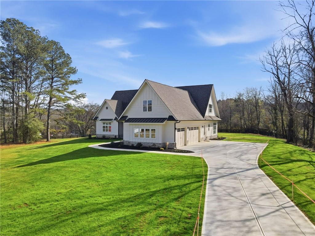 1248 Avery Road Canton, GA 30115 - Photo 4 of 64 a front view of a house with garden