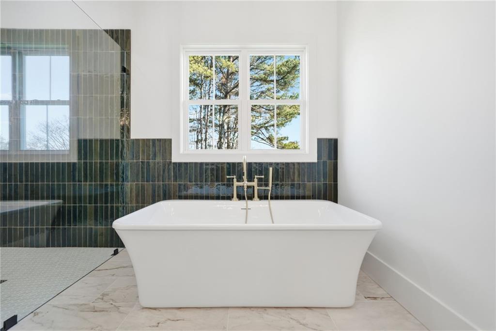 1248 Avery Road Canton, GA 30115 - Photo 42 of 64 a white bath tub sitting in a bathroom