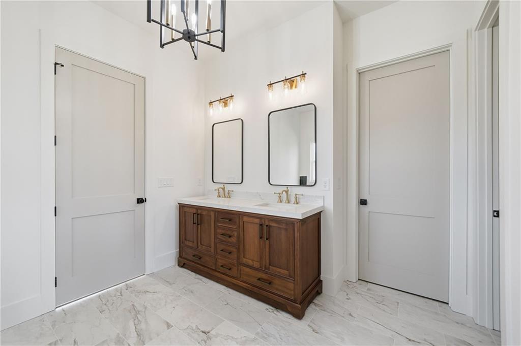 1248 Avery Road Canton, GA 30115 - Photo 43 of 64 a bathroom with a granite countertop sink and a mirror