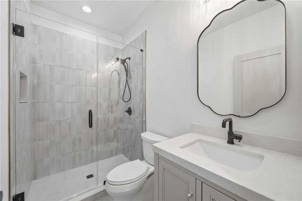 1248 Avery Road Canton, GA 30115 - Photo 53 of 64 a bathroom with a sink toilet and shower