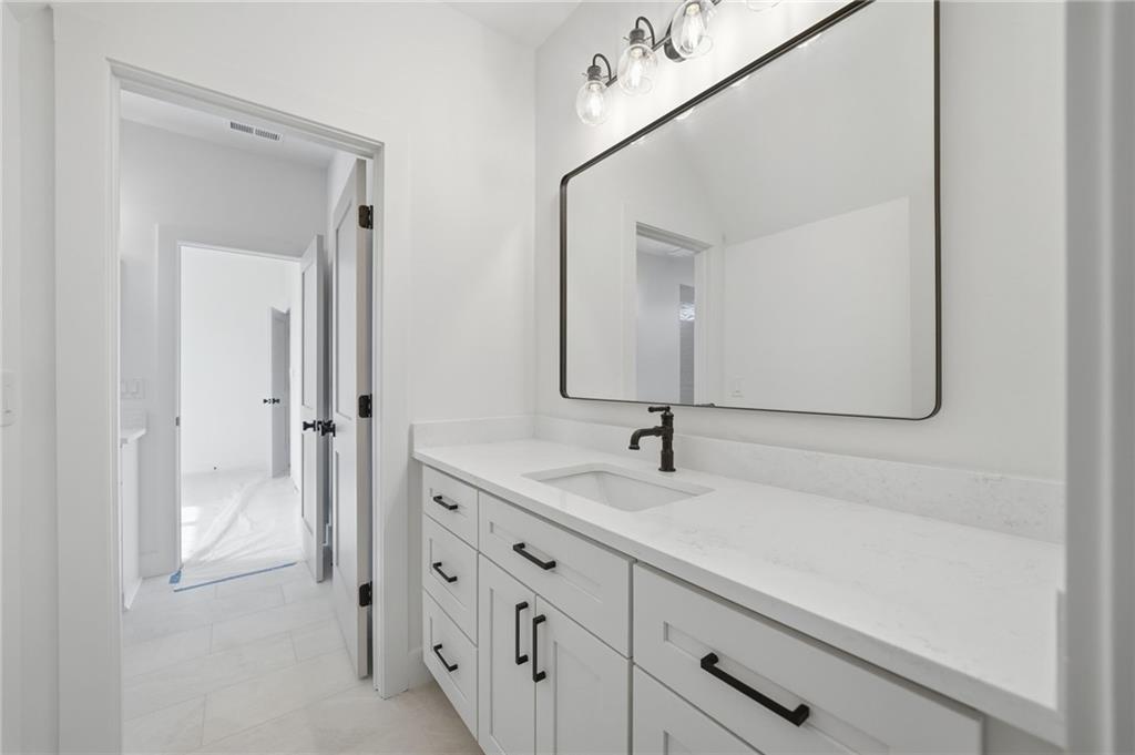 1248 Avery Road Canton, GA 30115 - Photo 59 of 64 a bathroom with a sink and a mirror