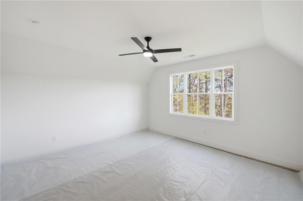 1248 Avery Road Canton, GA 30115 - Photo 60 of 64 an empty room with a window and a ceiling fan
