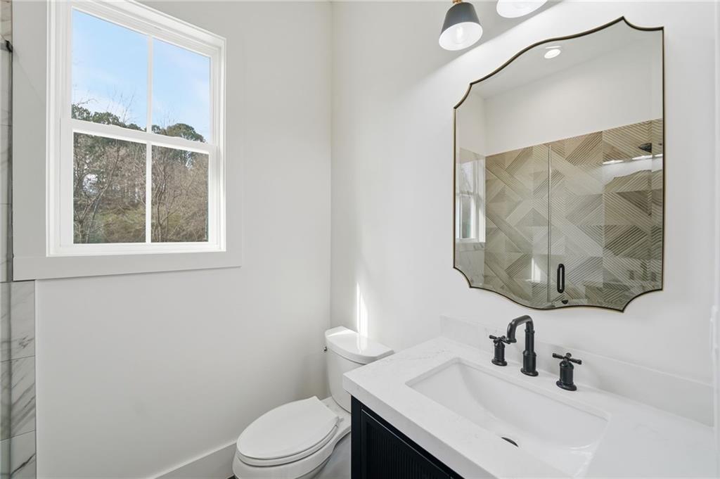 1248 Avery Road Canton, GA 30115 - Photo 62 of 64 a bathroom with a sink vanity mirror and toilet