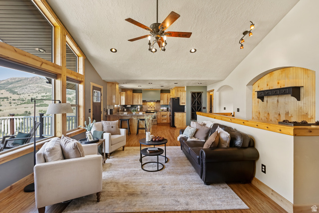 2013 North River View Road Huntsville, UT 84317 - Photo 10 of 53 Living room featuring a mountain view, ceiling fan, a high textured ceiling, and light wood finished floors