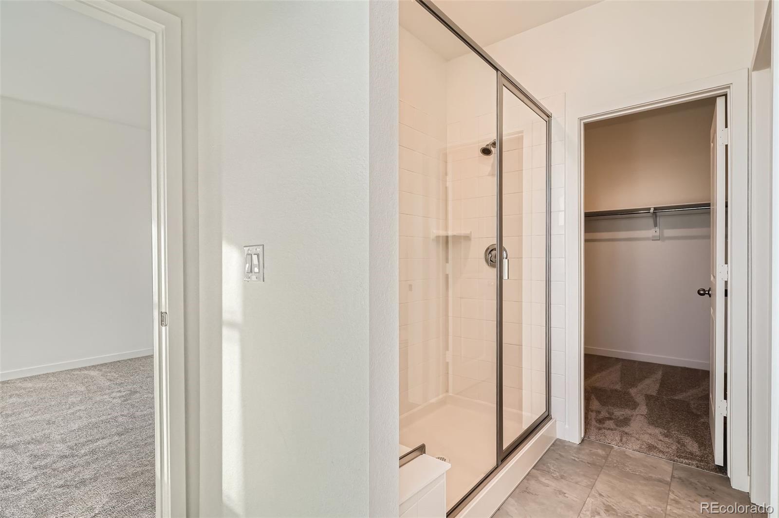 1979 South Gold Bug Way Aurora, CO 80018 - Photo 17 of 28 a bathroom with a shower and a glass door