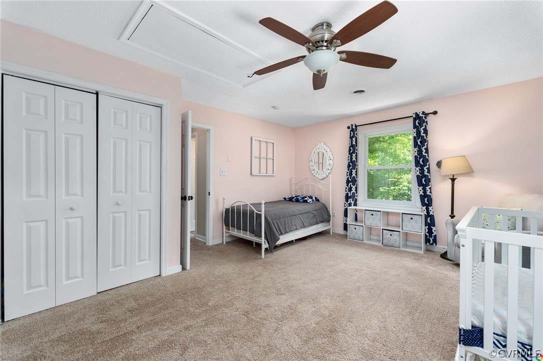 13571 Bailey Bridge Road Midlothian, VA 23112 - Photo 30 of 46 a spacious bedroom with a bed and a chandelier
