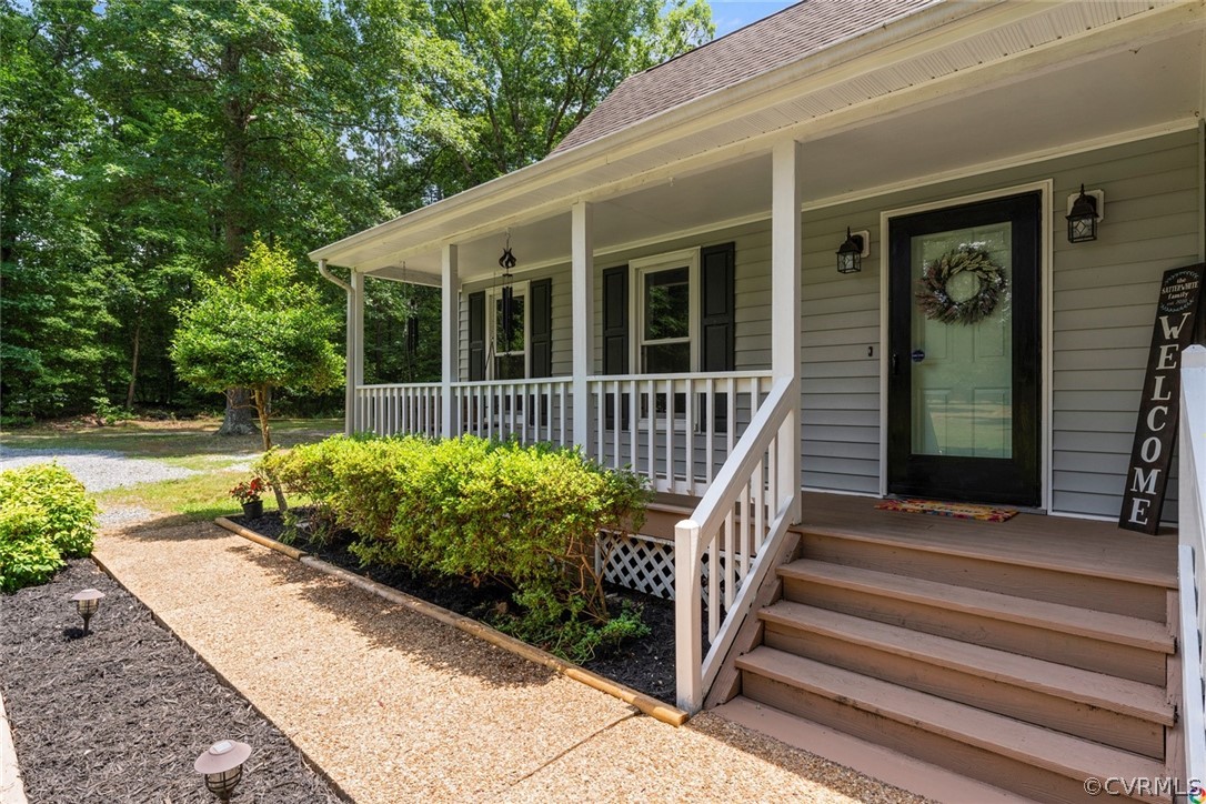 13571 Bailey Bridge Road Midlothian, VA 23112 - Photo 4 of 46 a view of a house with a small yard plants and large tree