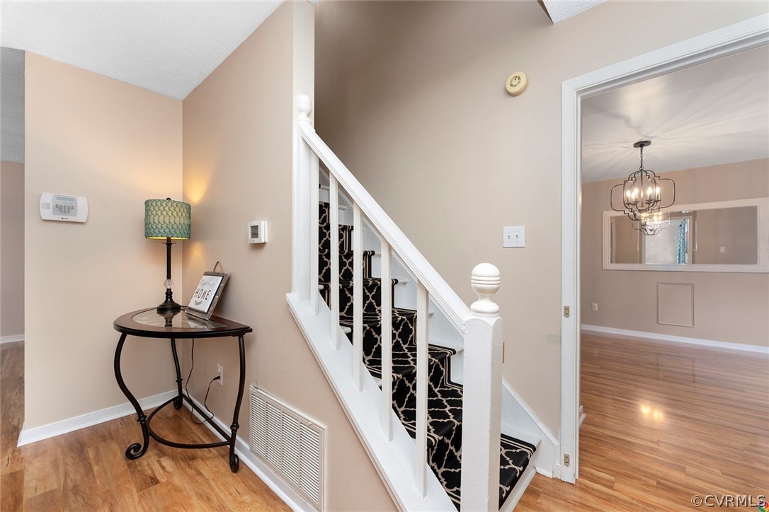 13571 Bailey Bridge Road Midlothian, VA 23112 - Photo 7 of 46 a view of a livingroom with wooden floor and stairs