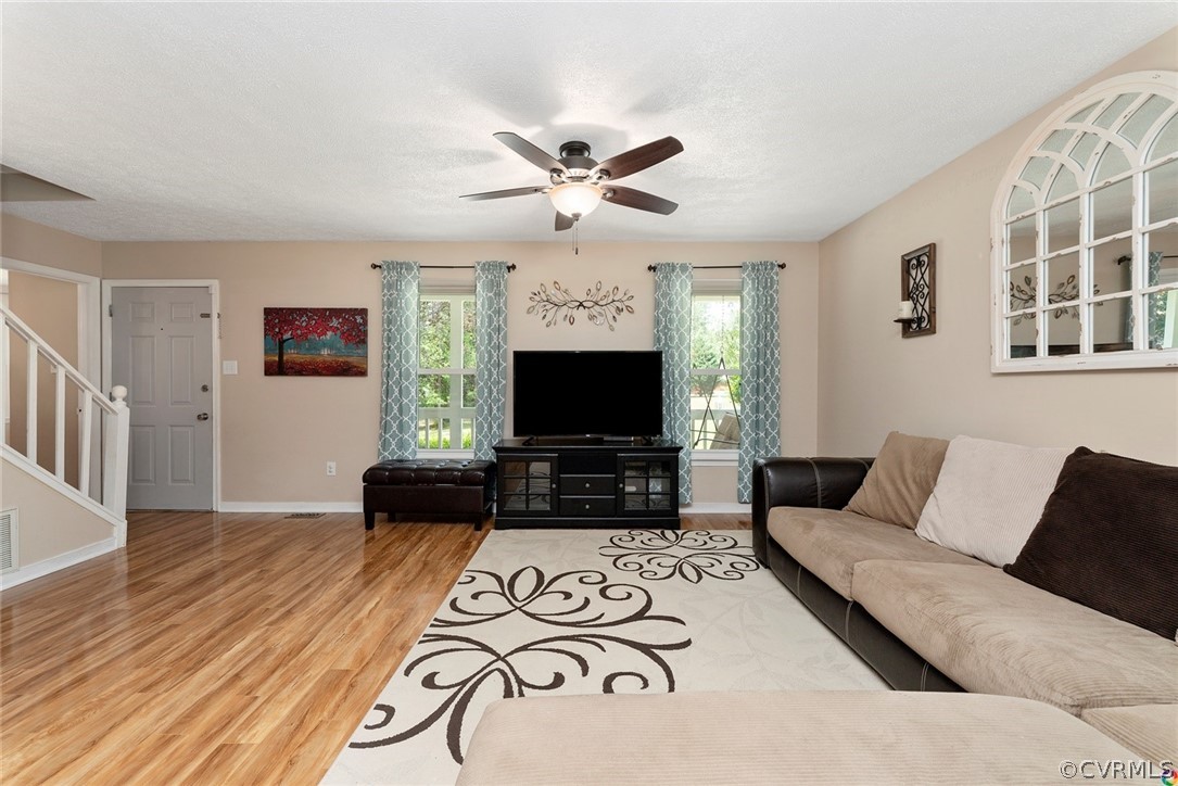 13571 Bailey Bridge Road Midlothian, VA 23112 - Photo 10 of 46 a living room with furniture a fireplace and a flat screen tv