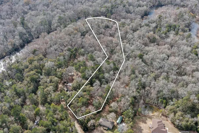 a view of a field with trees in the background
