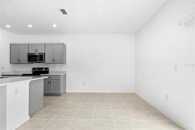 a kitchen with stainless steel appliances a refrigerator sink and microwave