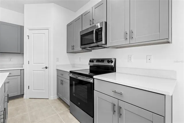 a kitchen with a sink stainless steel appliances and cabinets