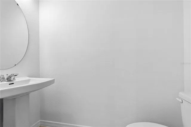 a view of staircase with white walls and a window