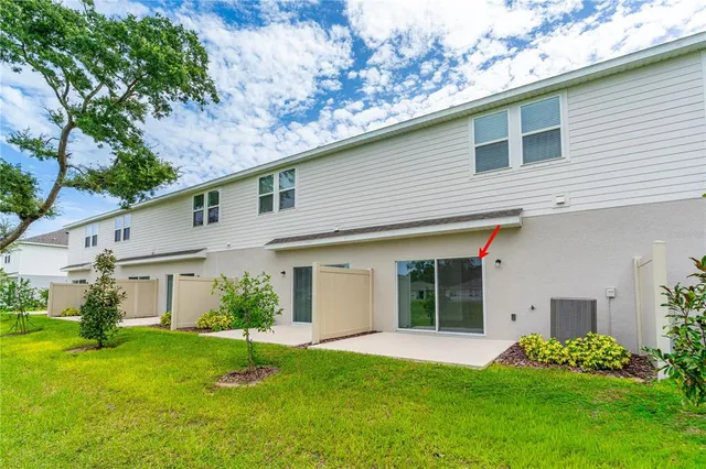 a view of a golf ground with large trees