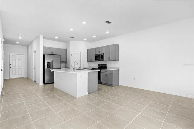 a view of a kitchen with microwave and cabinets