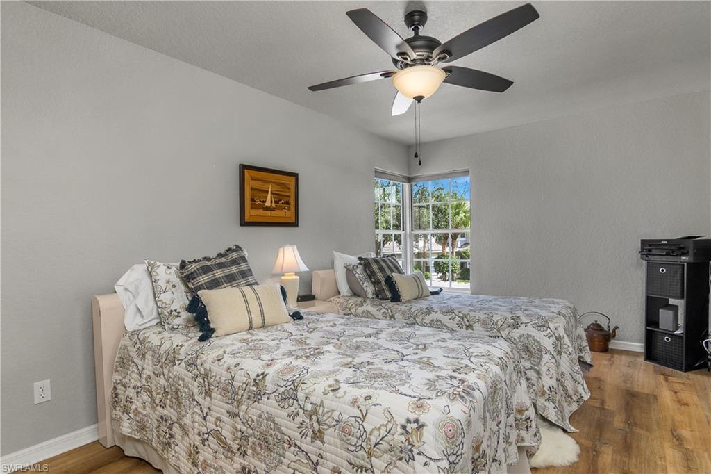 13061 Hamilton Harbour Drive, Unit R1 Naples, FL 34110 - Photo 14 of 23 Bedroom featuring light wood-style flooring and ceiling fan