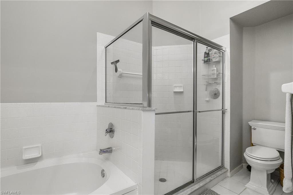 13061 Hamilton Harbour Drive, Unit R1 Naples, FL 34110 - Photo 18 of 23 Full bathroom with a bath, light tile patterned flooring, and a shower stall