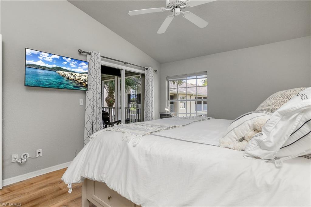 13061 Hamilton Harbour Drive, Unit R1 Naples, FL 34110 - Photo 19 of 23 Bedroom with light wood-type flooring, access to outside, lofted ceiling, and ceiling fan