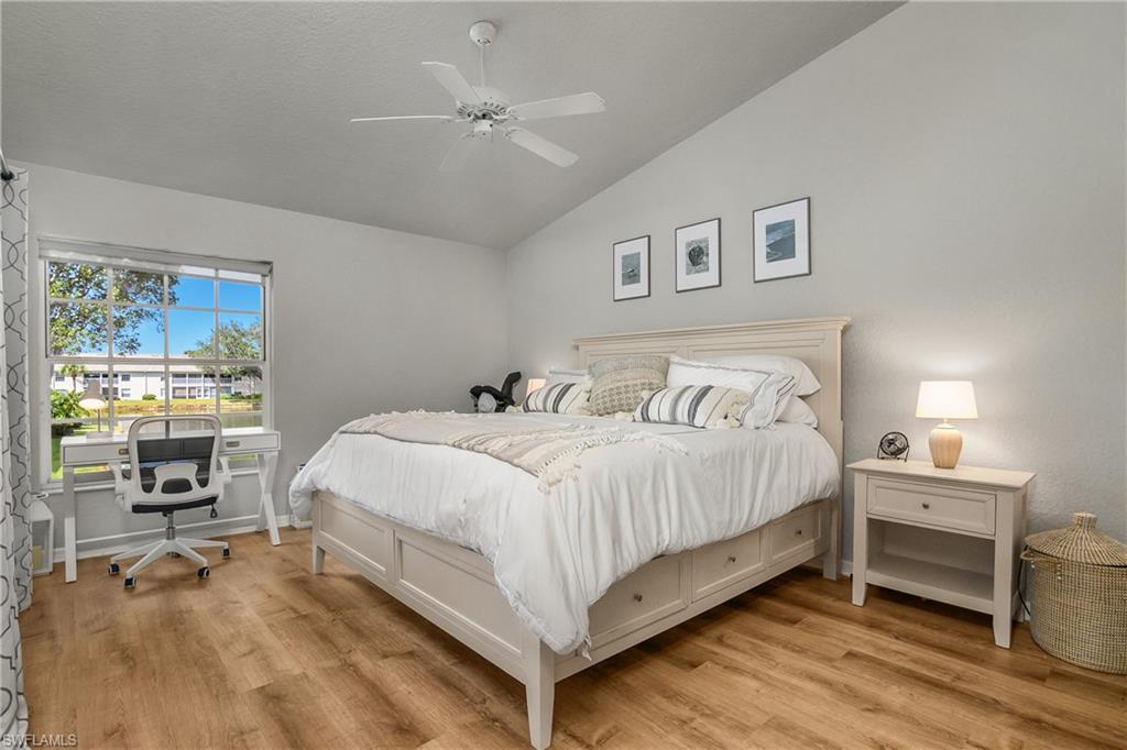 13061 Hamilton Harbour Drive, Unit R1 Naples, FL 34110 - Photo 20 of 23 Bedroom with lofted ceiling, light wood-style floors, ceiling fan, and a desk