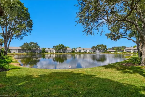 a view of a lake with houses in the background