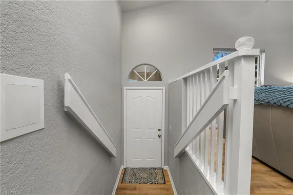 a view of staircase with railing and white walls