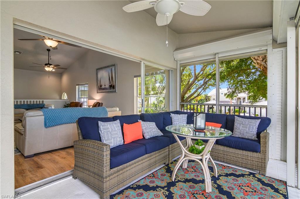 13061 Hamilton Harbour Drive, Unit R1 Naples, FL 34110 - Photo 6 of 23 Living room with vaulted ceiling, ceiling fan, and a sunroom