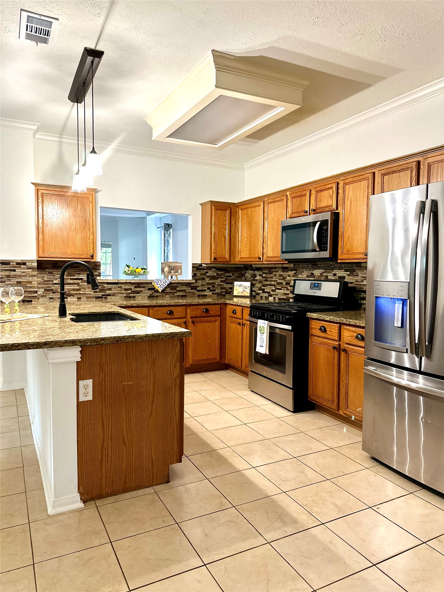 24914 Aughton Court Spring, TX 77389 - Photo 12 of 27 Open-concept kitchen featuring an oversized island